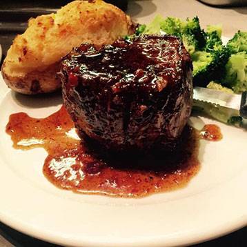 Glazed meat with twice baked potato and broccoli